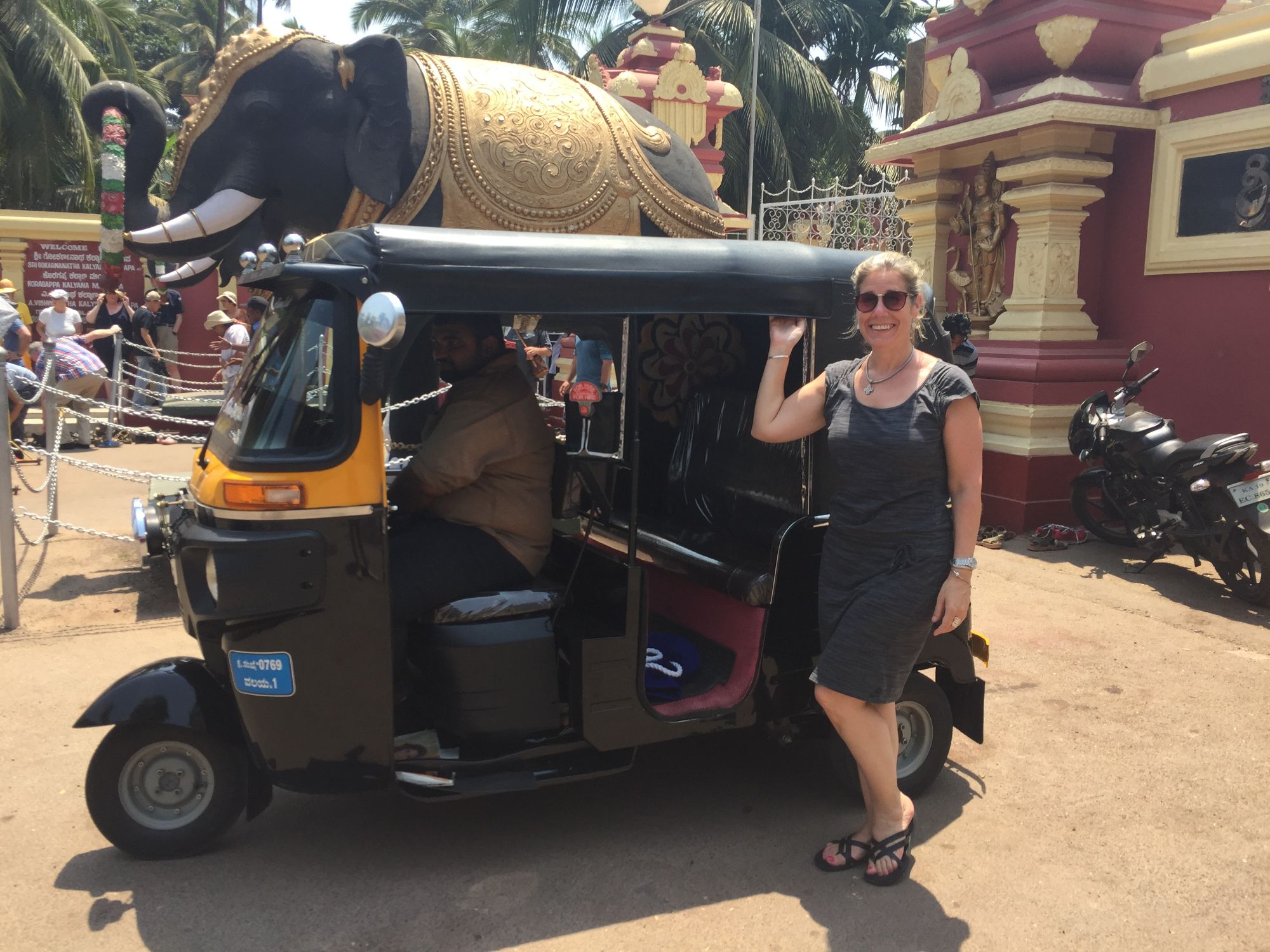 Sherry solo traveling standing next to a car
